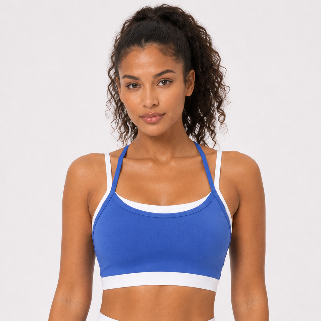 Badge blue__04_front-detail | Close-up front view of the layered sports bra in Badge Blue